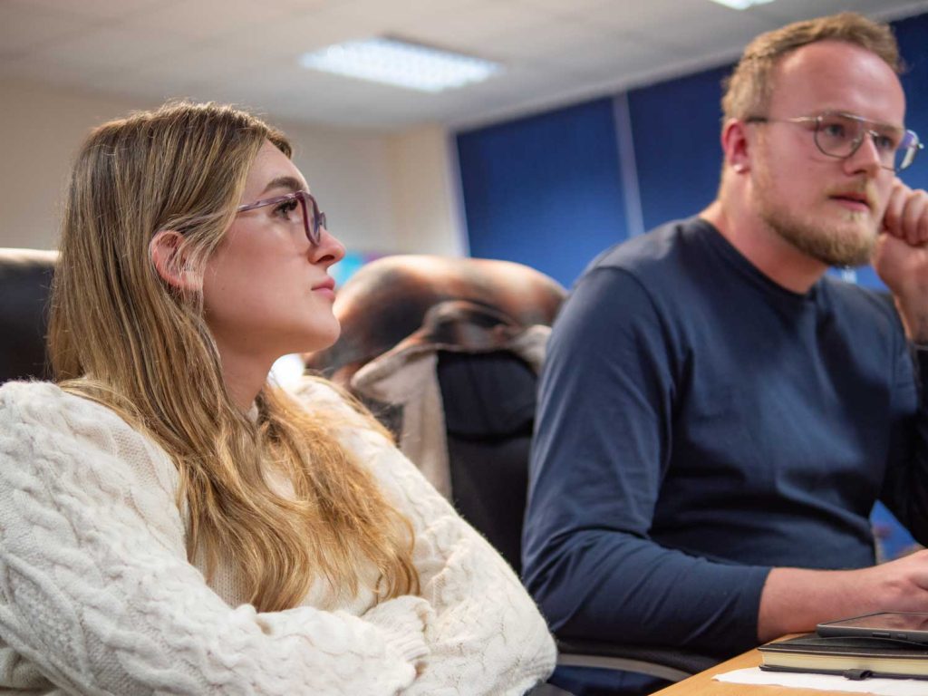 man and woman working at a desk together