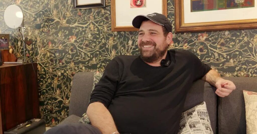 Man sitting on sofa smiling