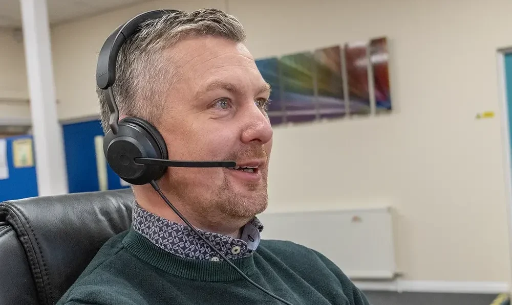 Man with headset on talking