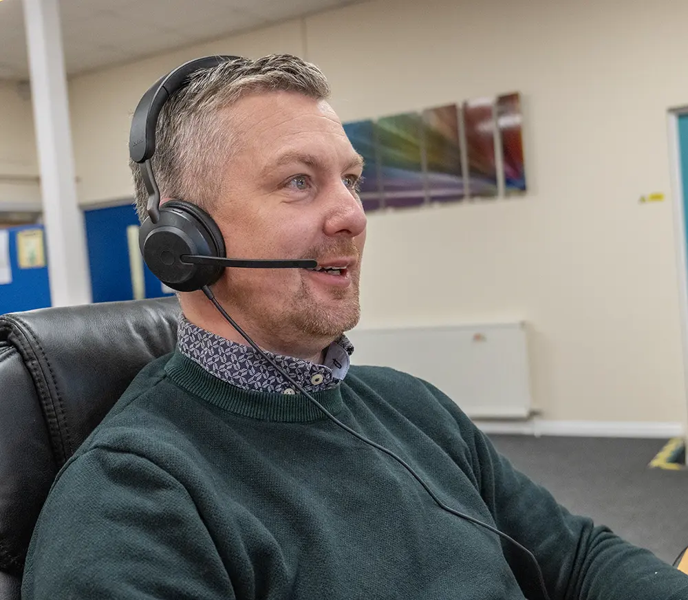 man using headset phone in office