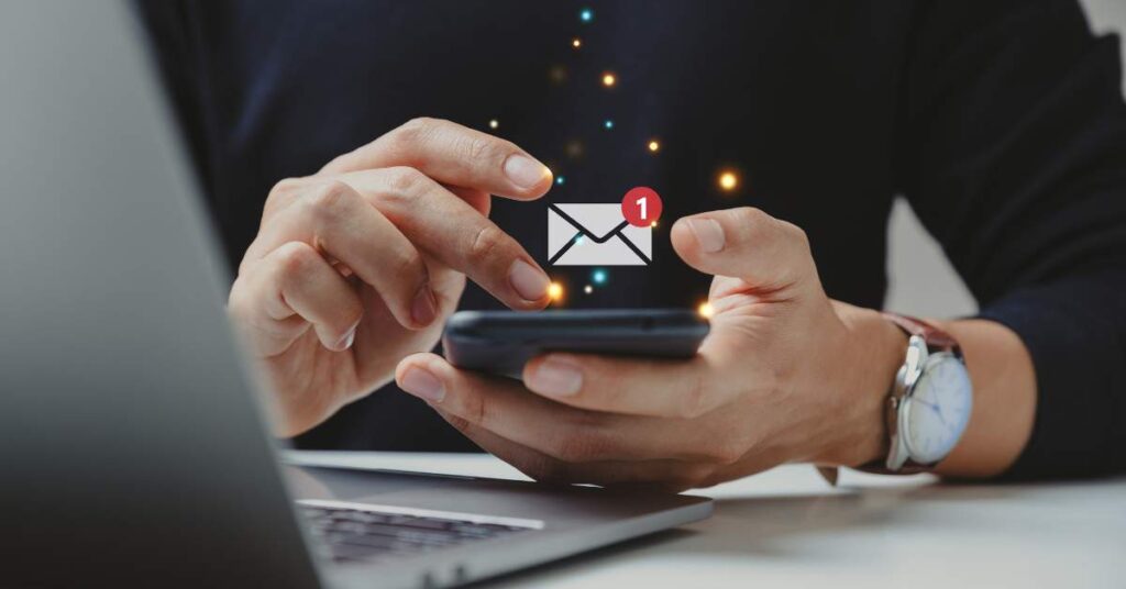 Man on phone with an email icon floating above