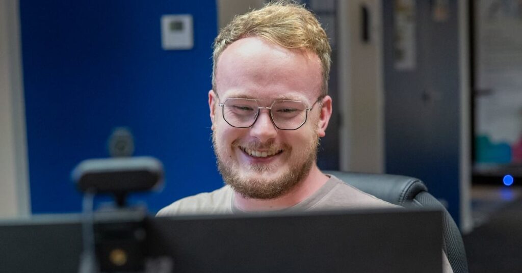 Man smiling at computer
