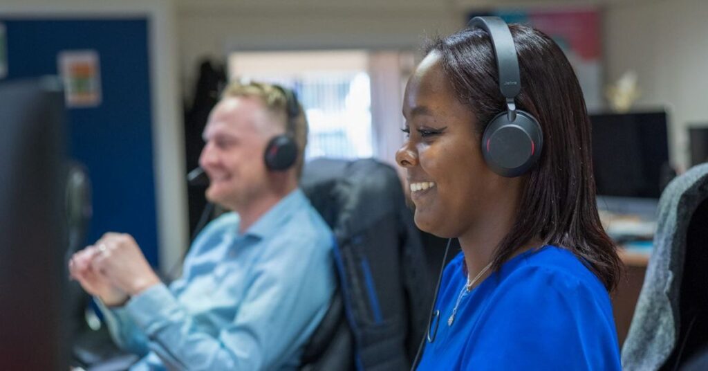 man and woman wearing a headset on a meeting