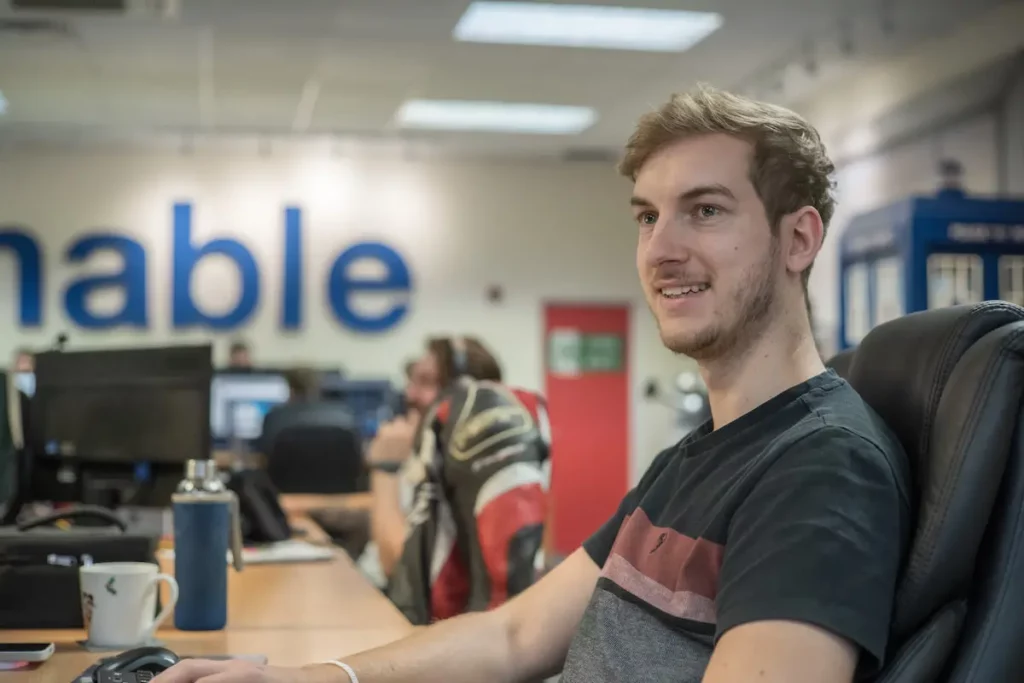 Man smiling sitting at a desk