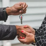 Realtor handing keys to client