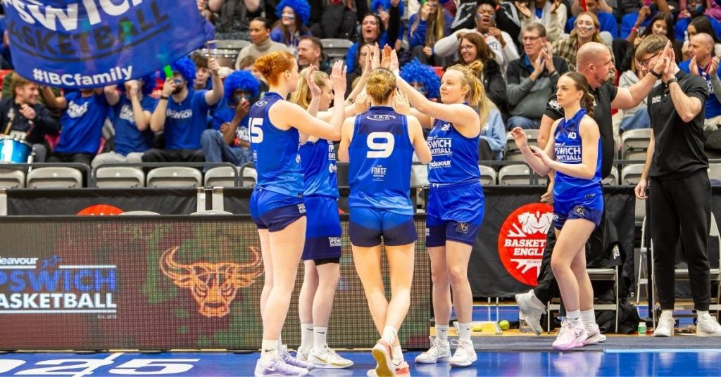 Ipswich basketball womens team high fiving at game
