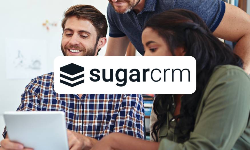 SugarCRM logo over three people at a desk working