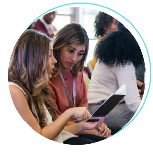 two women looking at event program