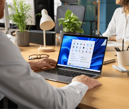 image of a person on a laptop using Windows 11