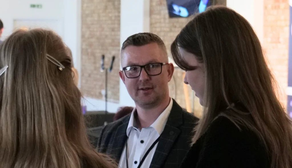 Image of three people talking in a circle