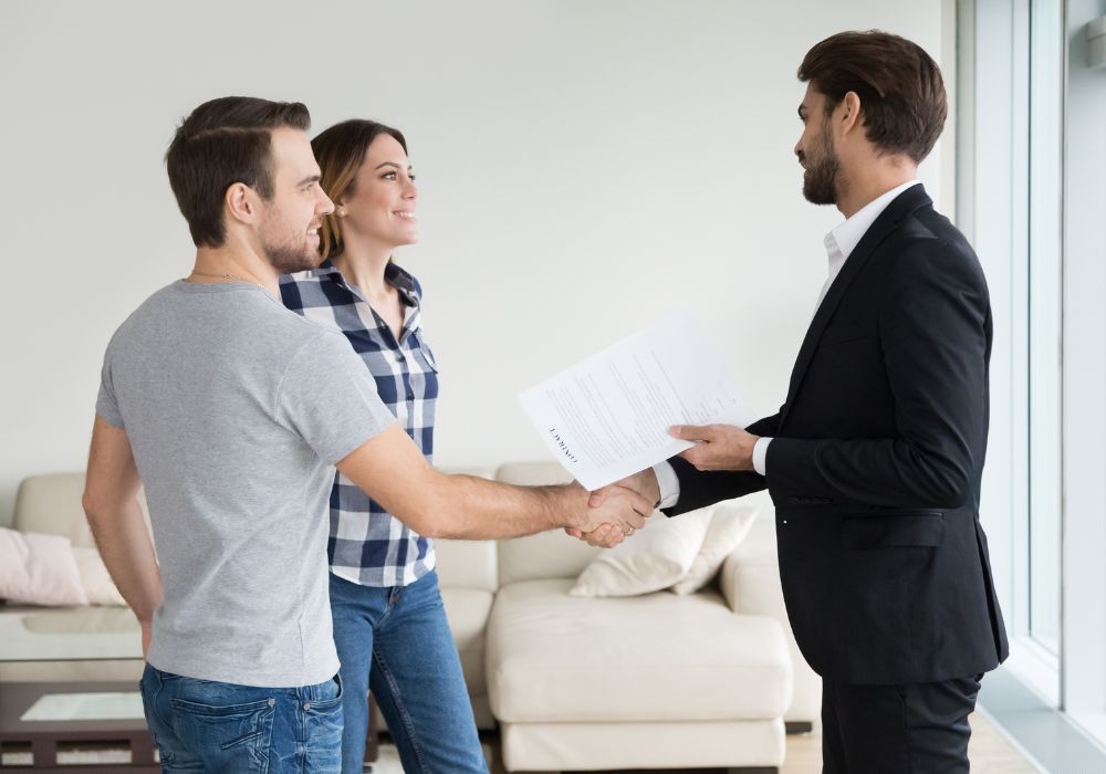 landlord shaking hands with tenants