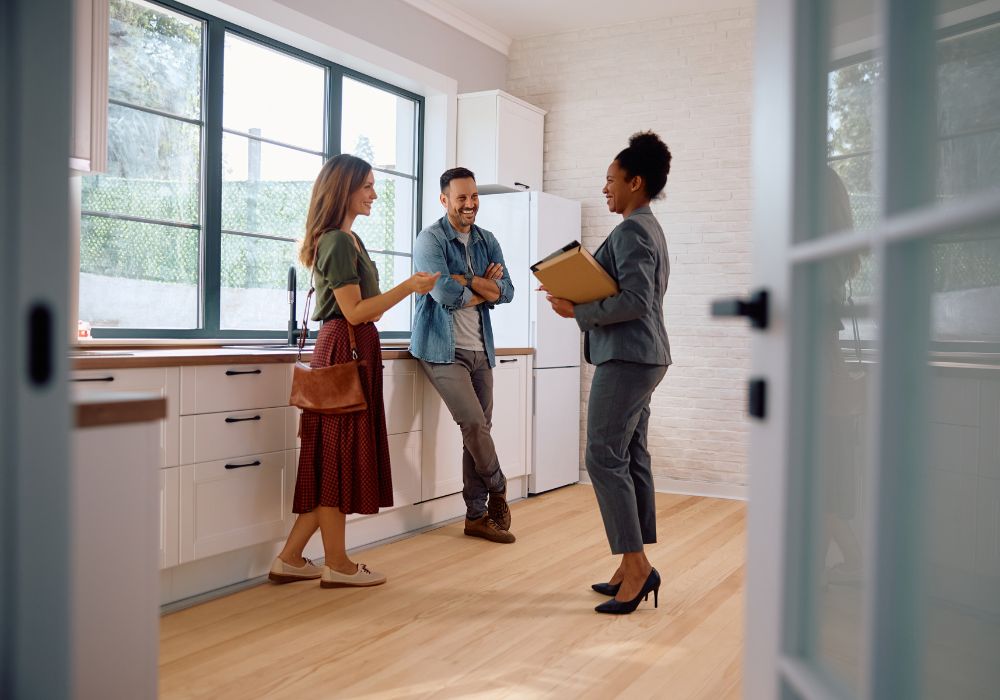 real estate agent showing home to couple